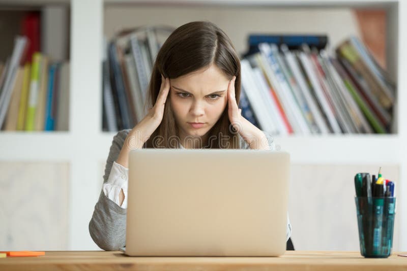 Focused concerned girl student learning difficult exam with lapt stock images Focused concerned girl student learning difficult exam with lapt stock images
