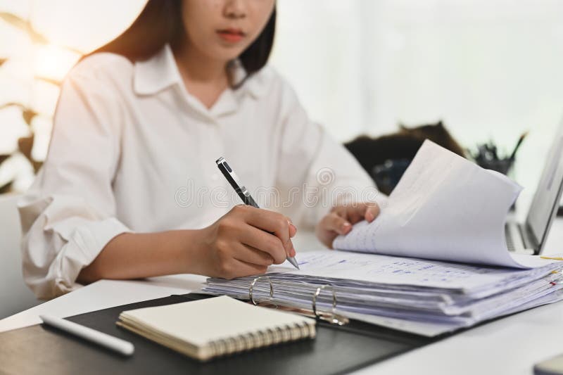 Focused Female Accounting Analyst Working Bookkeeping Documents