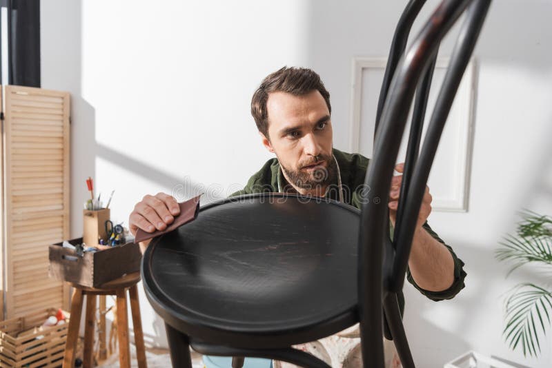 Focused Restorer Sanding Wooden Chair in Stock Image Image of