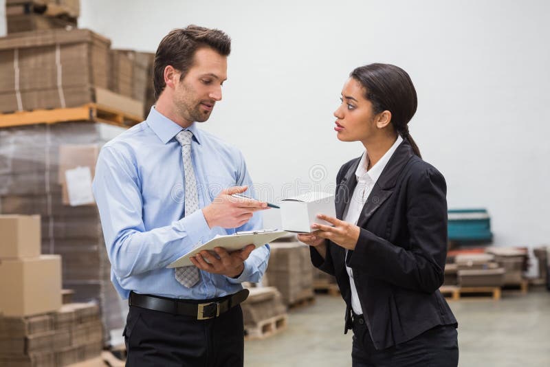 Focused warehouse managers working together royalty free stock images