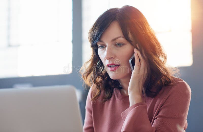 Focused young businesswoman hard at work in a modern office