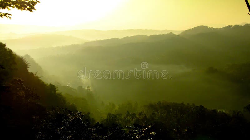 A fog in mountain at Tasikmalaya West Java, a fog envelop hill every morning, air is very clear. a hill located in Kampung Manangga, Karangjaya District. A fog in mountain at Tasikmalaya West Java, a fog envelop hill every morning, air is very clear. a hill located in Kampung Manangga, Karangjaya District