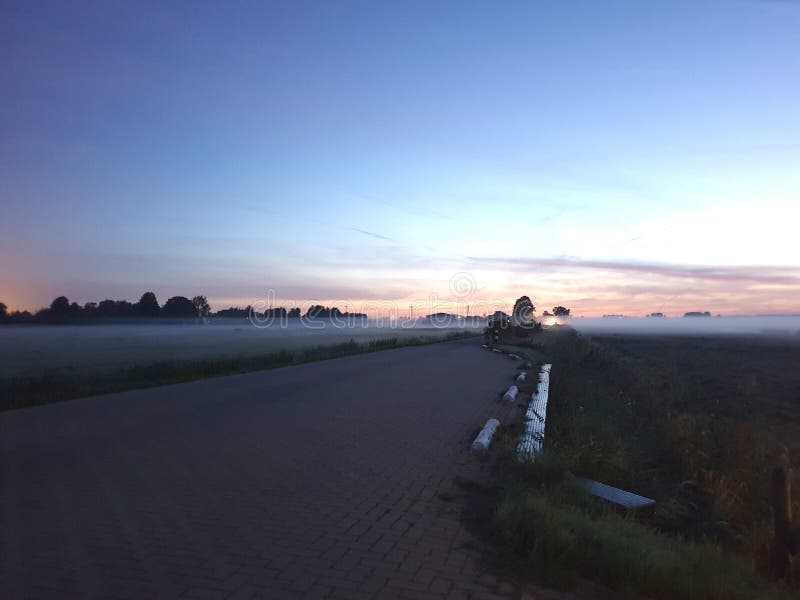 Fog over the meadows during sunrise in the Zuidplaspolder in Zevenhuizen the Netherlands. stock photos Fog over the meadows during sunrise in the Zuidplaspolder in Zevenhuizen the Netherlands. stock photos