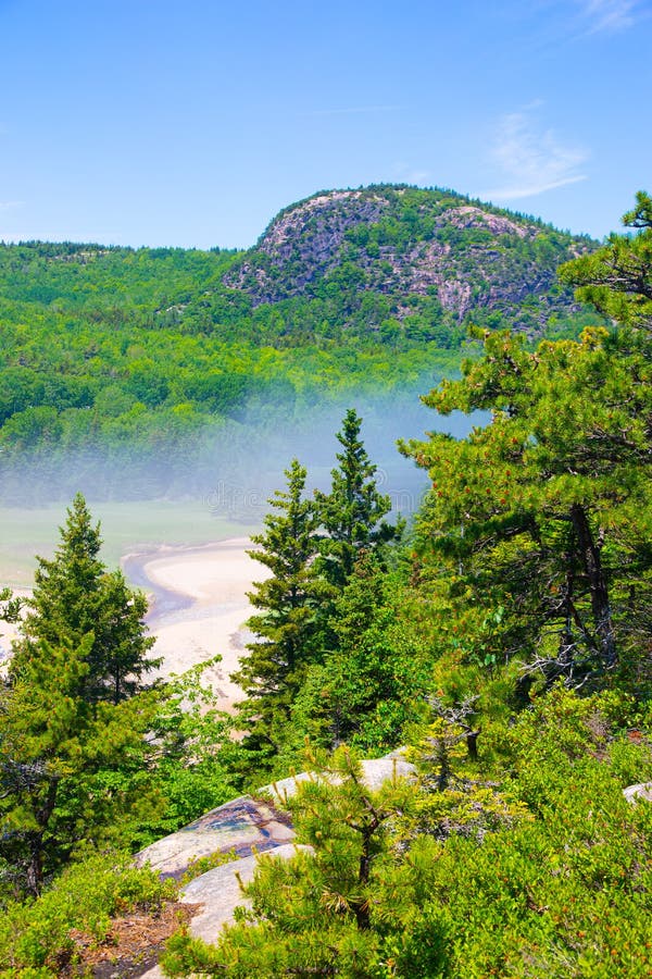 Fog rolling over Sand Beach in Acadia National Park, Maine, USA