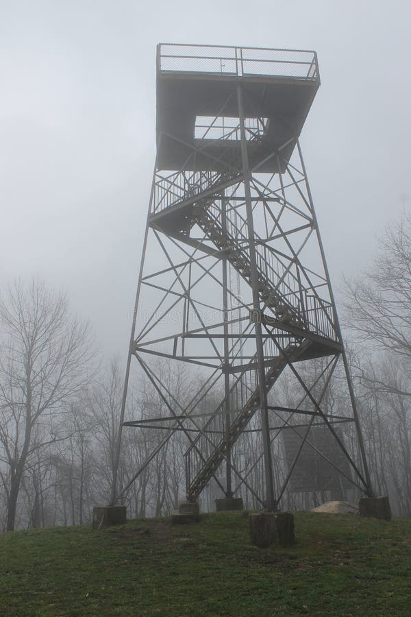 Foggy fire tower on the mountain