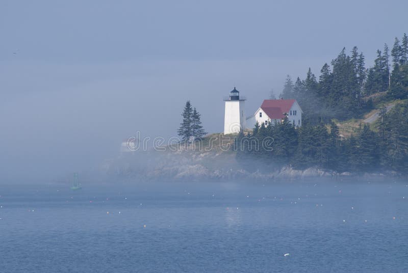 Foggy Island Lighthouse in Maine is Iluminated By the Sun Breaking Through the Fog
