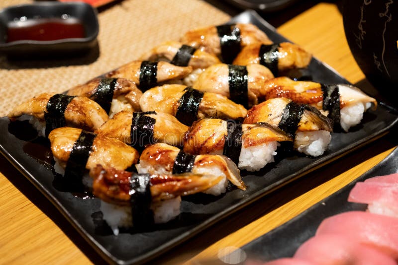 Foie Gras sushi and Unagi eel sushi on black tray