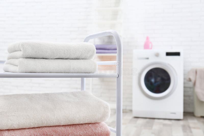 Folded Clean Terry Towels on Shelving Unit in Laundry Room Stock Image