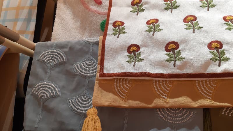 Folded fabrics with intricate embroidery and tassel details, showcasing various textures and patterns stock photos