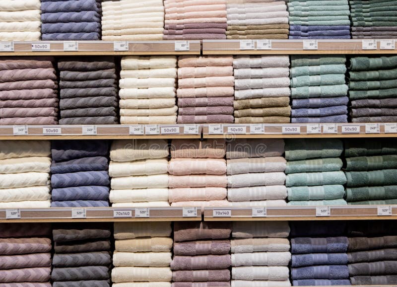 Folded Multicolored Towels on Shelves. Neatly Folded Clothes. Rack of