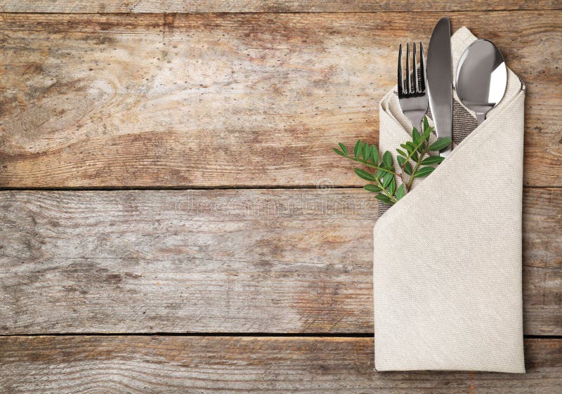 Folded napkin with fork, spoon and knife stock photos