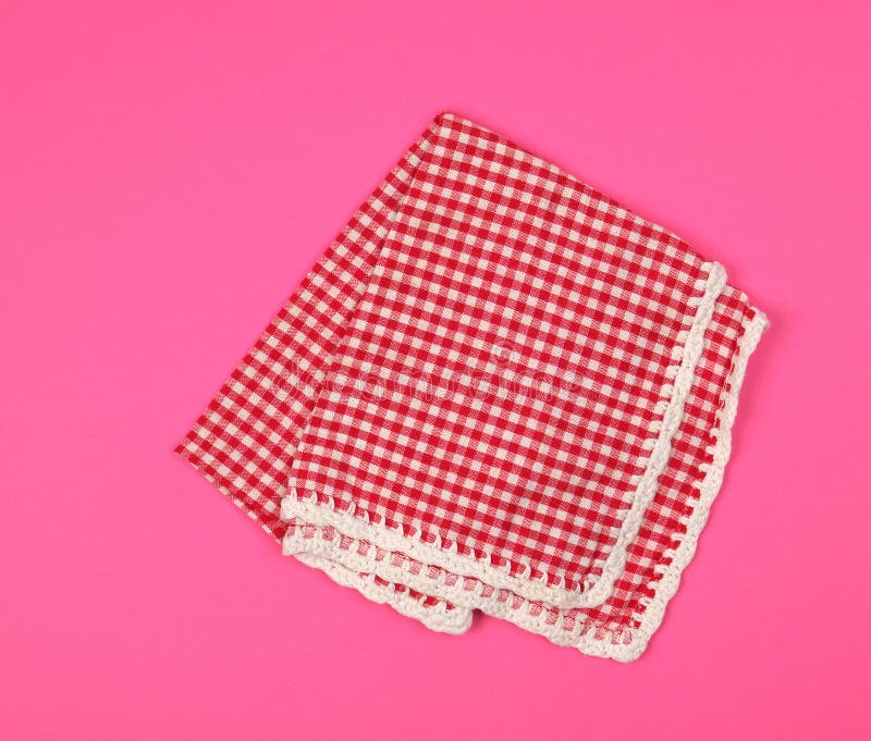 Folded Red Kitchen Towel in a Cage on a Pink Background Stock Image