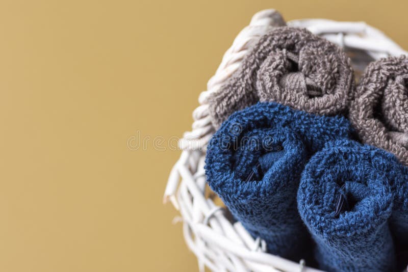 Folded rolled pure cotton terry washcloth towels in wicker basket on olive green bathroom wall background. Zero waste reusable eco royalty free stock photos Folded rolled pure cotton terry washcloth towels in wicker basket on olive green bathroom wall background. Zero waste reusable eco royalty free stock photos