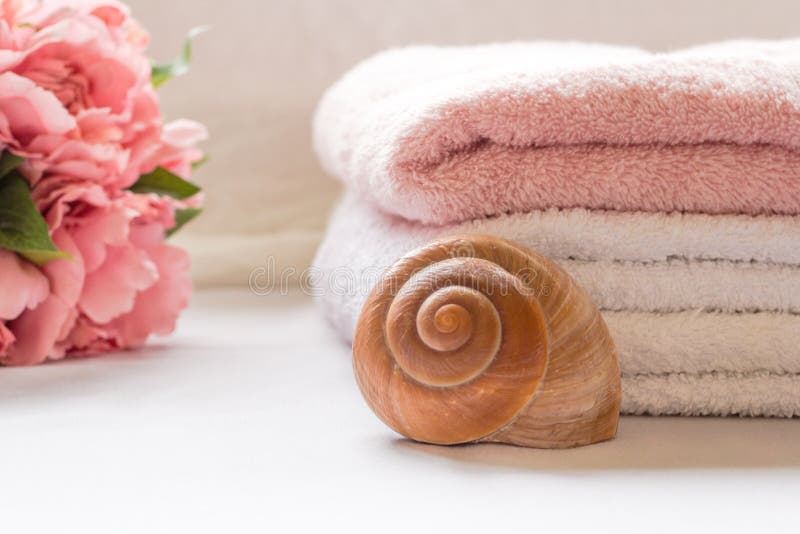 Folded towels on bathroom counter with flowers