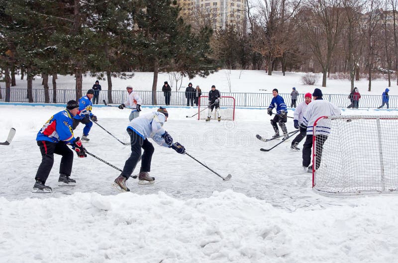 Folk som spelar amatörmässig hockey i stadsskridskoåkningisbanan Vinter som spelar, gyckel, snö royaltyfria foton Folk som spelar amatörmässig hockey i stadsskridskoåkningisbanan Vinter som spelar, gyckel, snö royaltyfria foton