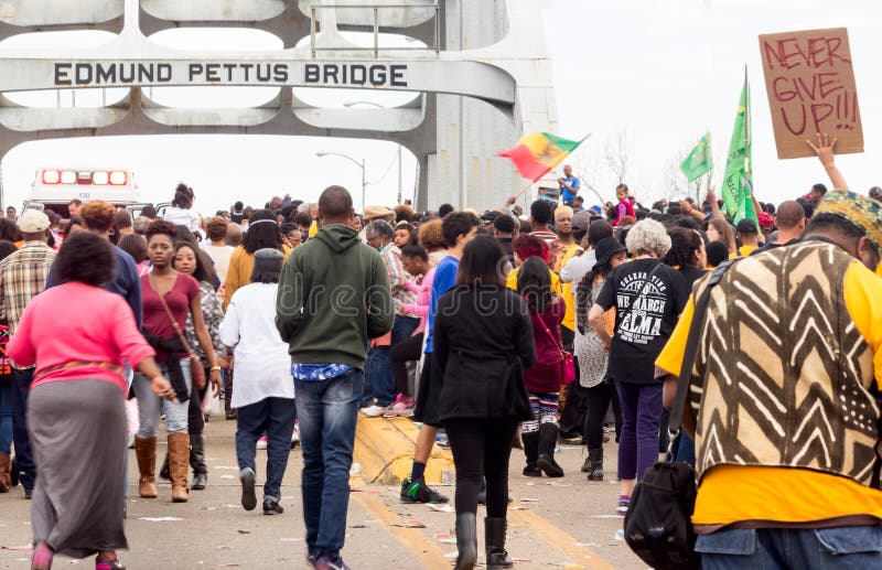 A group of people with signs and flags at the 50th Anniversary of Bloody Sunday in Selma, Alabma 2015 conduct peaceful marches across, Edmund, Pettus, bridge. A group of people with signs and flags at the 50th Anniversary of Bloody Sunday in Selma, Alabma 2015 conduct peaceful marches across, Edmund, Pettus, bridge