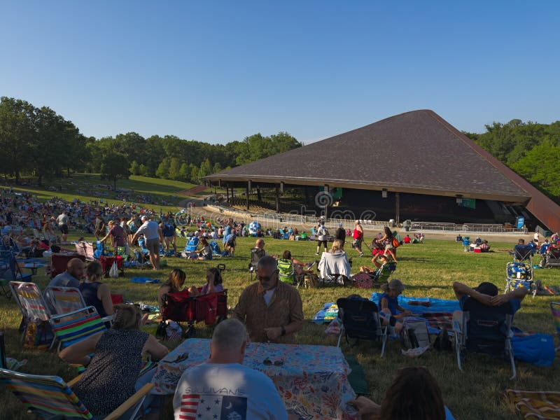 Cuyahoga Falls, OH, USA - July 4, 2023: Concertgoers begin gathering on the lawn at the Blossom Music Center for a Fourth of July concert by the Blossom Festival Band. Cuyahoga Falls, OH, USA - July 4, 2023: Concertgoers begin gathering on the lawn at the Blossom Music Center for a Fourth of July concert by the Blossom Festival Band