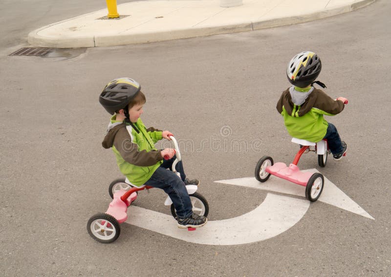 A young boy riding his tricycle following directions just like daddy said. A young boy riding his tricycle following directions just like daddy said.