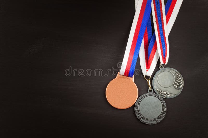 Folâtre des médailles sur un fond en bois Collection de médailles pour les gagnants Récompenses dans les sports photographie stock Folâtre des médailles sur un fond en bois Collection de médailles pour les gagnants Récompenses dans les sports photographie stock