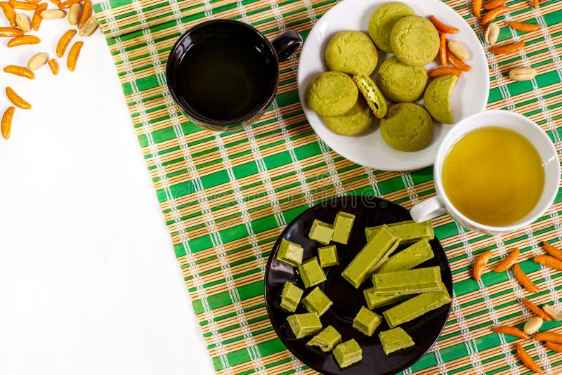 Fond blanc avec un bonbon japonais, fait avec le matcha et les tasses de thé vert photographie stock libre de droits Fond blanc avec un bonbon japonais, fait avec le matcha et les tasses de thé vert photographie stock libre de droits