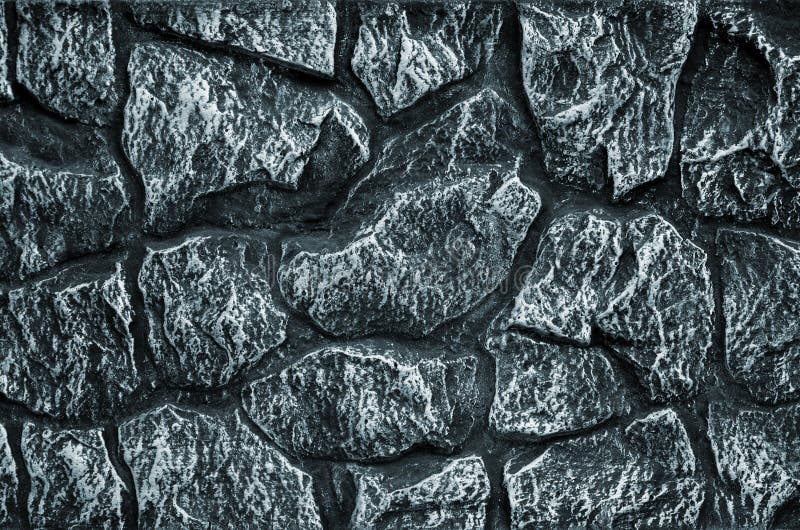 Stone wall background - building feature. Texture of thick and strong wall of rough stones of various shapes and sizes. Stone wall background - building feature. Texture of thick and strong wall of rough stones of various shapes and sizes