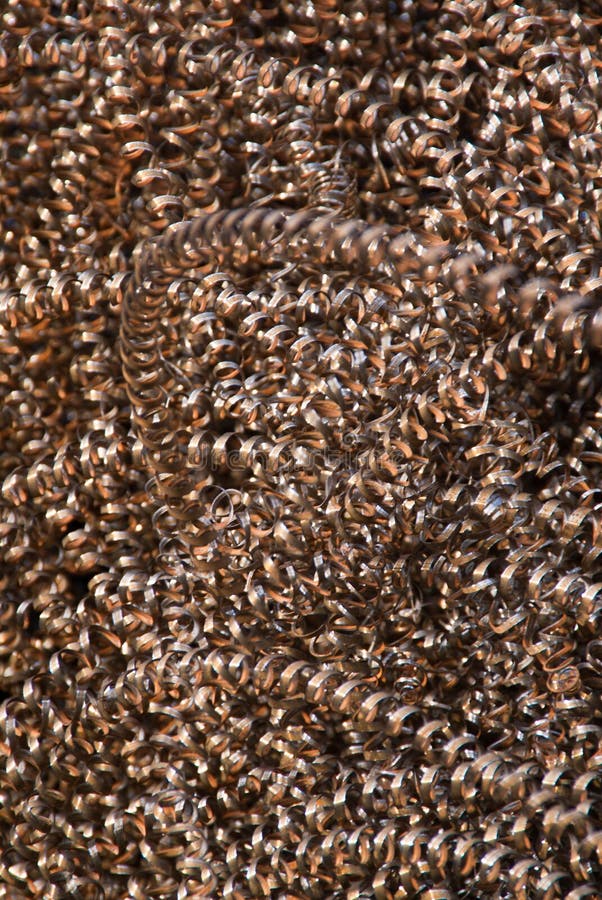 An abstract background of copper-colored metal shavings (swarf). An abstract background of copper-colored metal shavings (swarf)