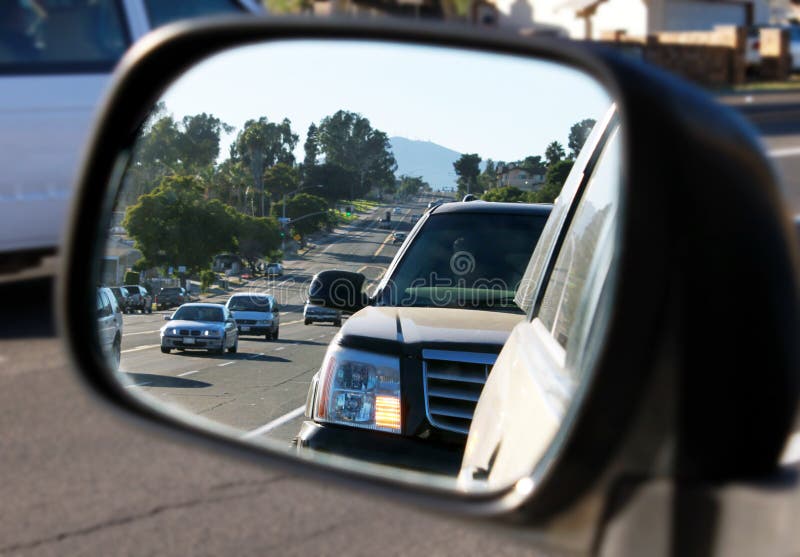 Side view mirror check if it is safe to merge into street traffic. Side view mirror check if it is safe to merge into street traffic