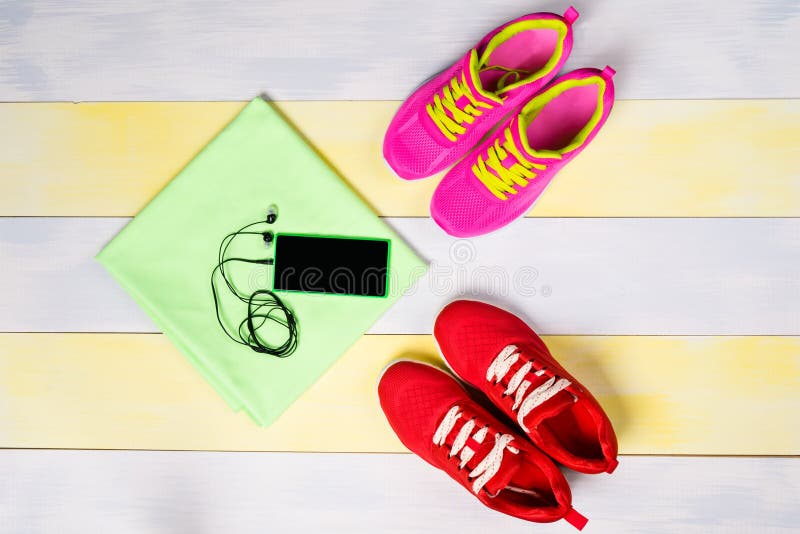 Bright background for jogging, with two pairs of shoes and a music phone. Bright background for jogging, with two pairs of shoes and a music phone