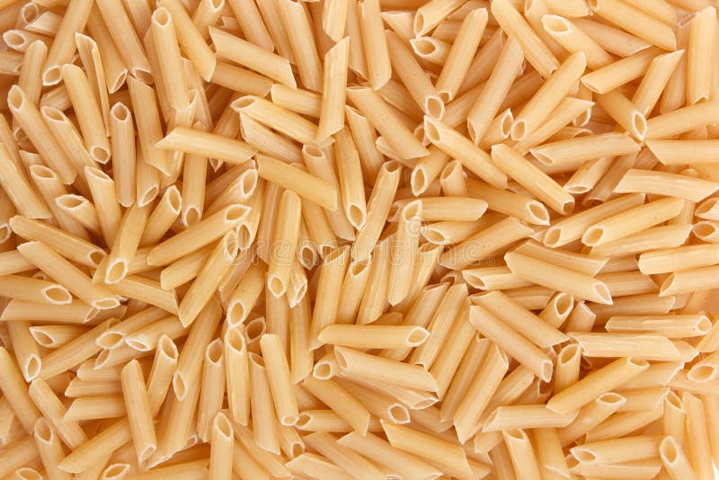 Fondo crudo de la comida de las pastas italianas de los macarrones o ascendente cercano de la textura imágenes de archivo libres de regalías Fondo crudo de la comida de las pastas italianas de los macarrones o ascendente cercano de la textura imágenes de archivo libres de regalías