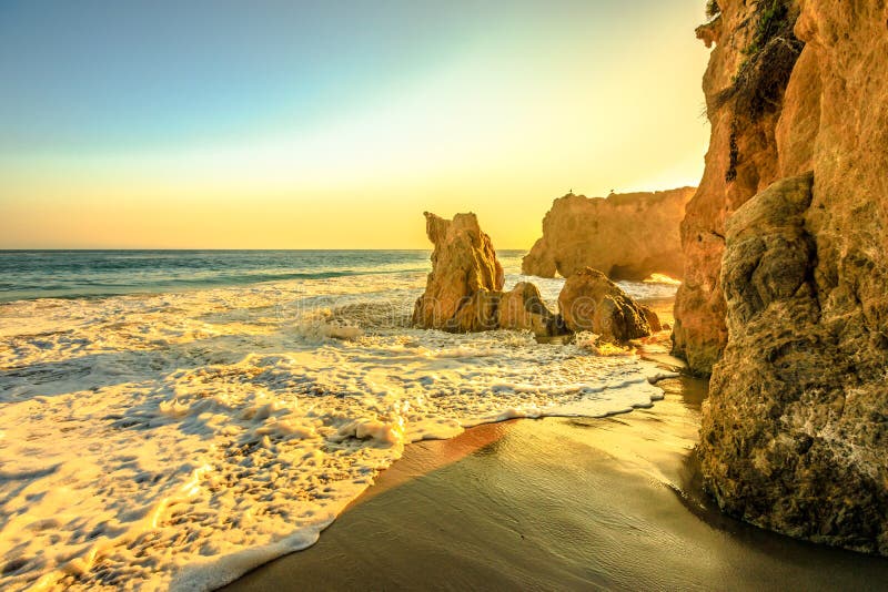 Sunset sea background in California West coast wallpaper. El Matador Beach at beautiful sunset light, CA, United States. Pillars, boulders and rock formations of most photographed Malibu beach. Sunset sea background in California West coast wallpaper. El Matador Beach at beautiful sunset light, CA, United States. Pillars, boulders and rock formations of most photographed Malibu beach.