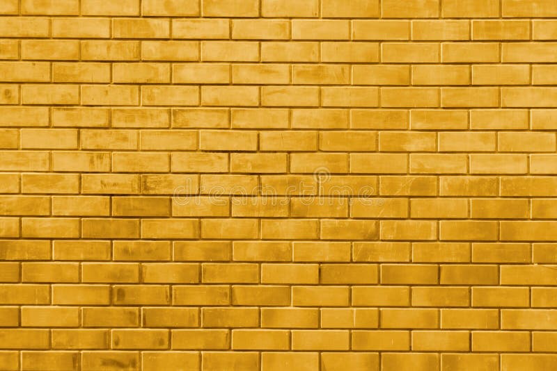 Fondo de la textura del extracto de la pared de ladrillo del oro amarillo fotografía de archivo libre de regalías Fondo de la textura del extracto de la pared de ladrillo del oro amarillo fotografía de archivo libre de regalías