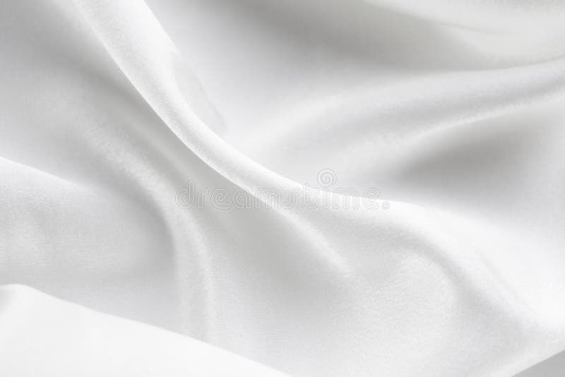 Fondo de los dobleces de mentira de la tela blanca en la tabla imágenes de archivo libres de regalías Fondo de los dobleces de mentira de la tela blanca en la tabla imágenes de archivo libres de regalías