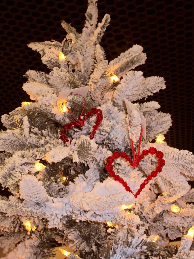New year background. Decoration consists of two red hearts on the Christmas tree. Merry Christmas. Year of the rooster, cock, bantam. Christmas pattern 2017. St. Valentines day background. New year background. Decoration consists of two red hearts on the Christmas tree. Merry Christmas. Year of the rooster, cock, bantam. Christmas pattern 2017. St. Valentines day background.