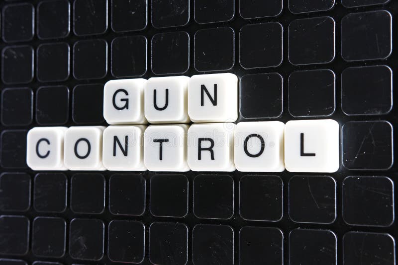 Gun control text word title caption label cover backdrop background. Alphabet letter toy blocks on black reflective background. gun control. Gun control text word title caption label cover backdrop background. Alphabet letter toy blocks on black reflective background. gun control.