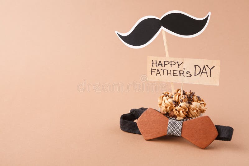 Fathers day background with copy space, cupcake, bow tie and mustache with greeting card. Fathers day background with copy space, cupcake, bow tie and mustache with greeting card
