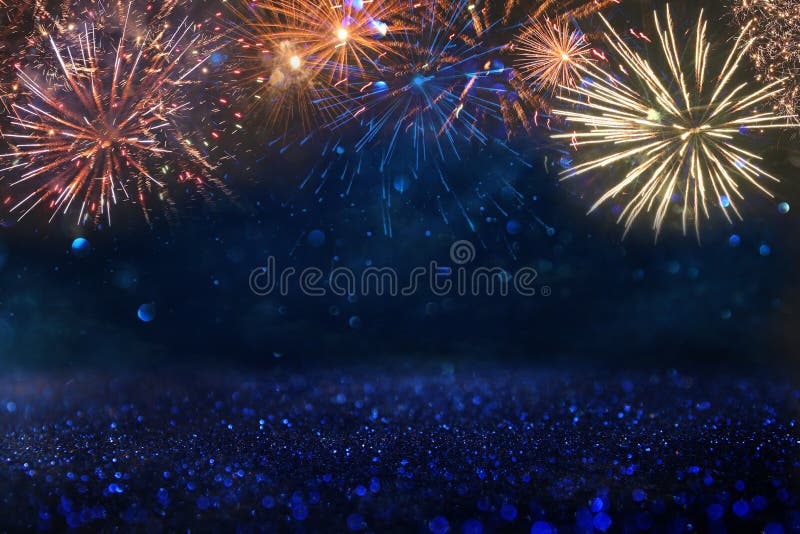 Abstract gold, black and blue glitter background with fireworks. christmas eve, 4th of july holiday concept. Abstract gold, black and blue glitter background with fireworks. christmas eve, 4th of july holiday concept