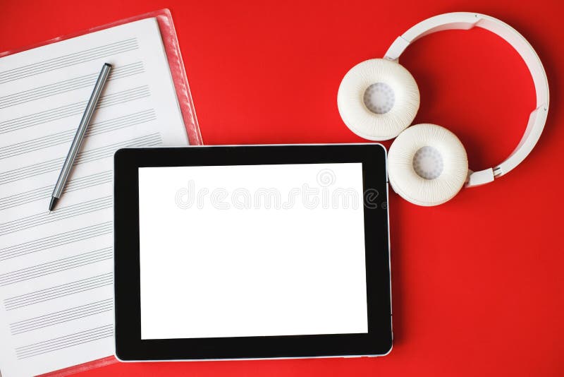 Top view open music book, headphones and a pen on a red background. mock up for a music lessons. Top view open music book, headphones and a pen on a red background. mock up for a music lessons