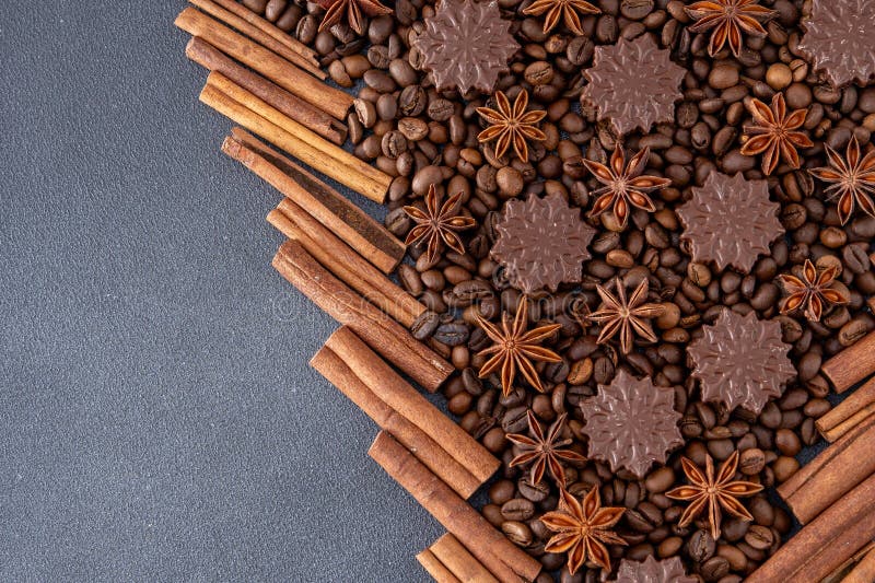 Food background. Coffee beans, cinnamon sticks, anise stars and chocolate candies.