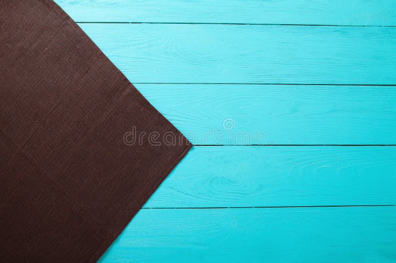 Food cafe restaurant concept. Brown tablecloth on blue wooden background. Top view and copy space. Mock up