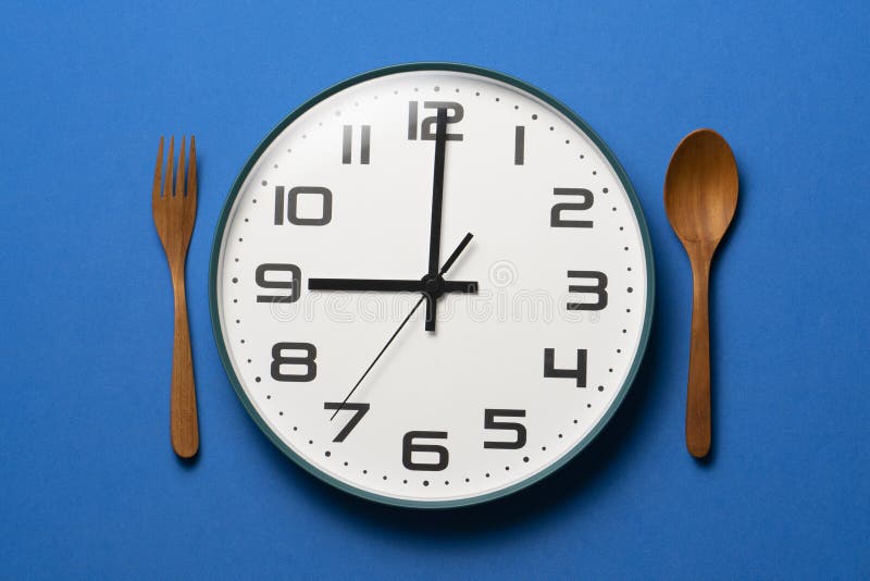 Food Clock Spoon and Fork, Healthy Food Breakfast Concept on Blue