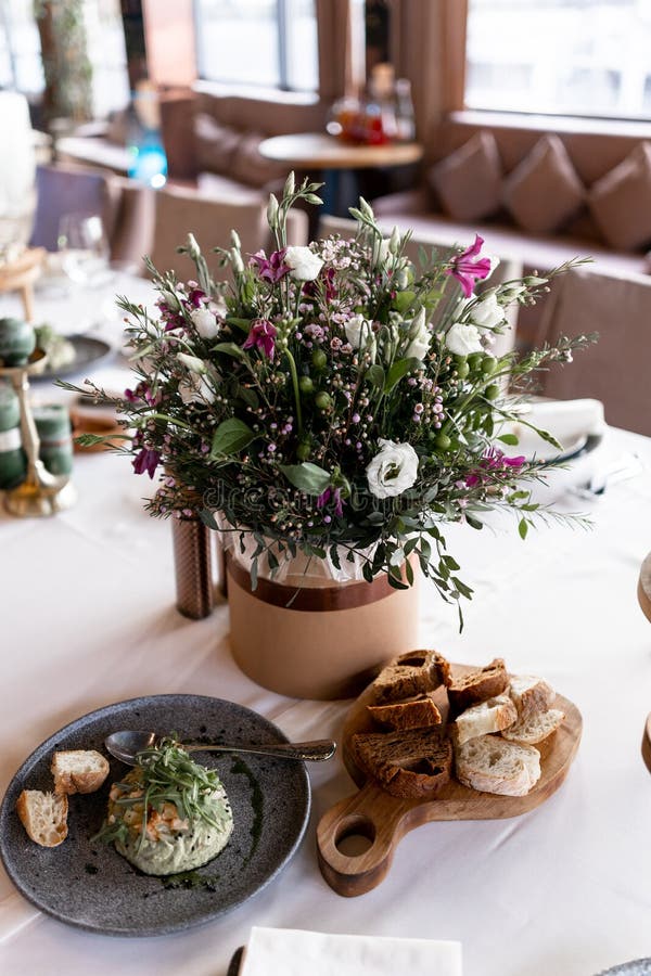 Food and Decoration of Flowers on a Festive Table in a Restaurant Stock