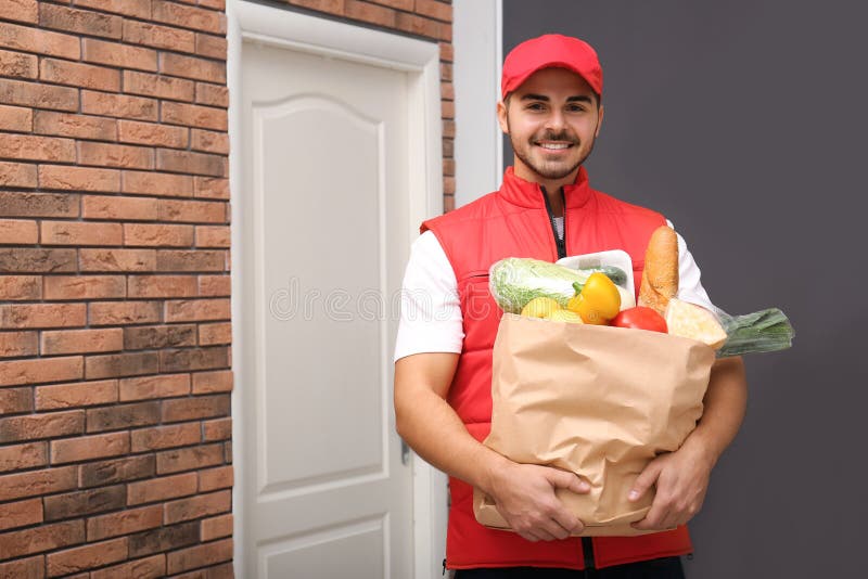 Food Delivery Courier Holding Paper Bag with Products. Space for Text