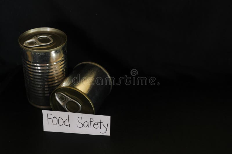 Food Safety Concept. Labeled Canned Food in Dark Black Background Stock