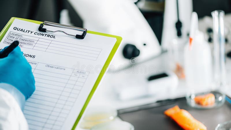 Food Safety and Quality Management. Inspector Filling Out Quality Control Form in a Laboratory