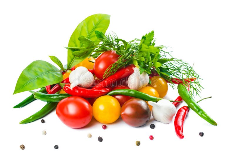 food setting with fresh ripe red, yellow, black cherry tomatoes, garlic, pepper and greens is isolated on the white background