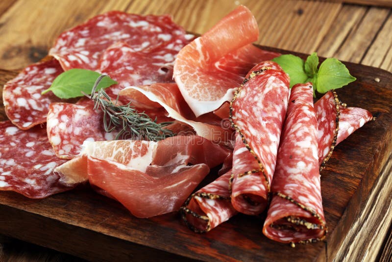 Food tray with delicious salami, raw ham and italian crudo or jamon. Meat platter with selection royalty free stock image Food tray with delicious salami, raw ham and italian crudo or jamon. Meat platter with selection royalty free stock image