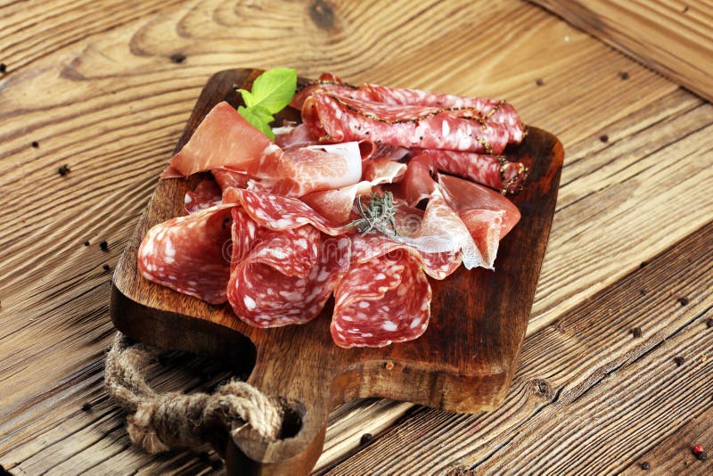 Food tray with delicious salami, raw ham and italian crudo or jamon. Meat platter with selection stock images Food tray with delicious salami, raw ham and italian crudo or jamon. Meat platter with selection stock images
