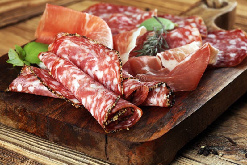 Food tray with delicious salami, raw ham and italian crudo or jamon. Meat platter with selection royalty free stock photography Food tray with delicious salami, raw ham and italian crudo or jamon. Meat platter with selection royalty free stock photography