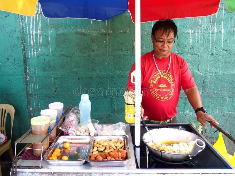 A Food Vendor Cooks Fish Balls, Sausages and Quail Eggs Which he