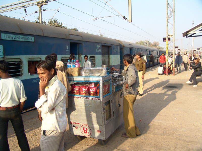 Snack vendor on Railway platform. A food vendor sells snack and tea on trolly during Train halt at an Indian village Railway station stock images Snack vendor on Railway platform. A food vendor sells snack and tea on trolly during Train halt at an Indian village Railway station stock images